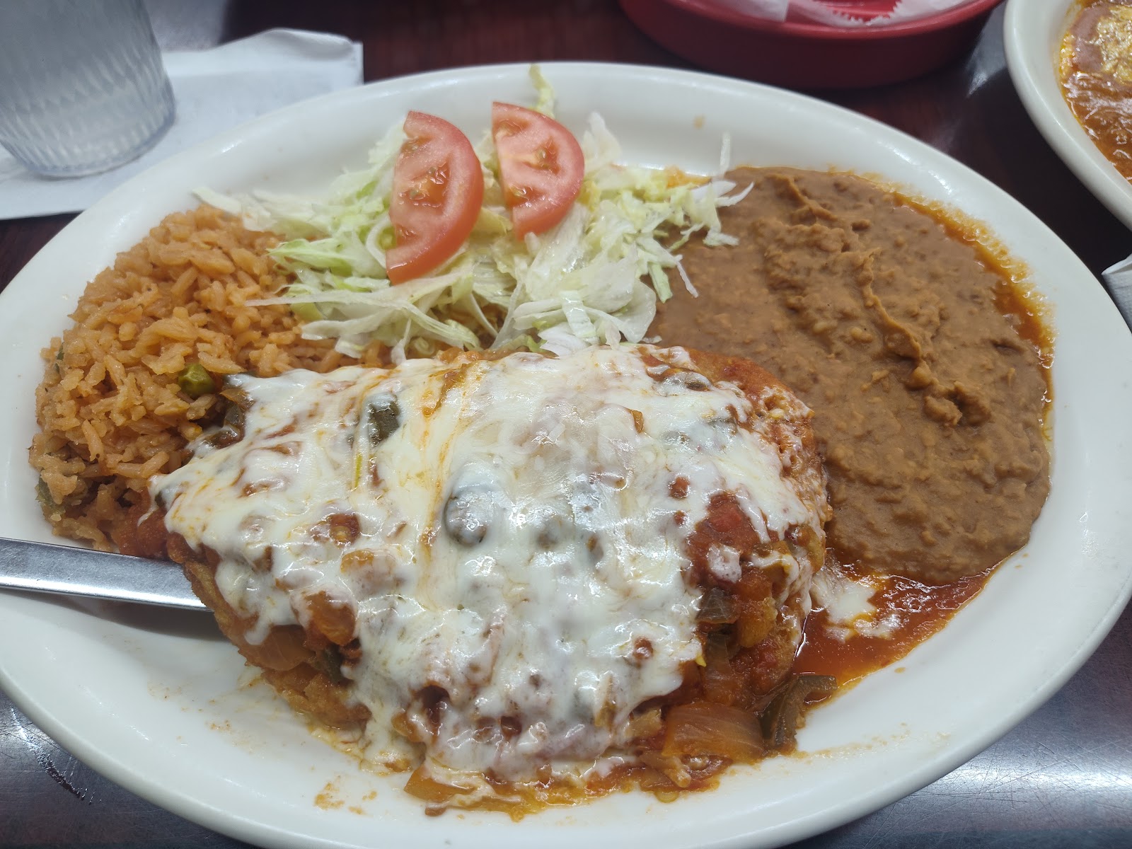 Chile relleno plate topped with melted cheese